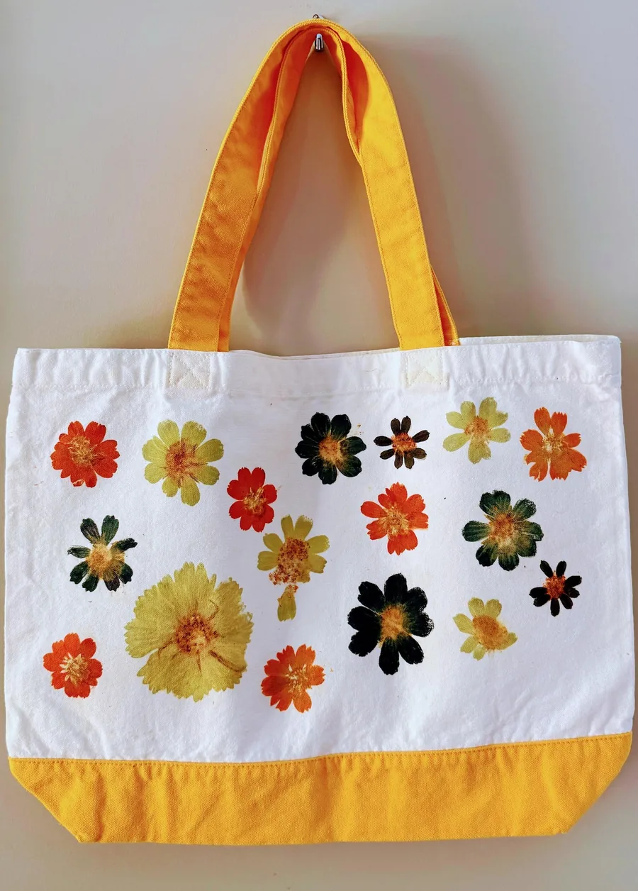 A cotton tote printed with pounded flower pigments