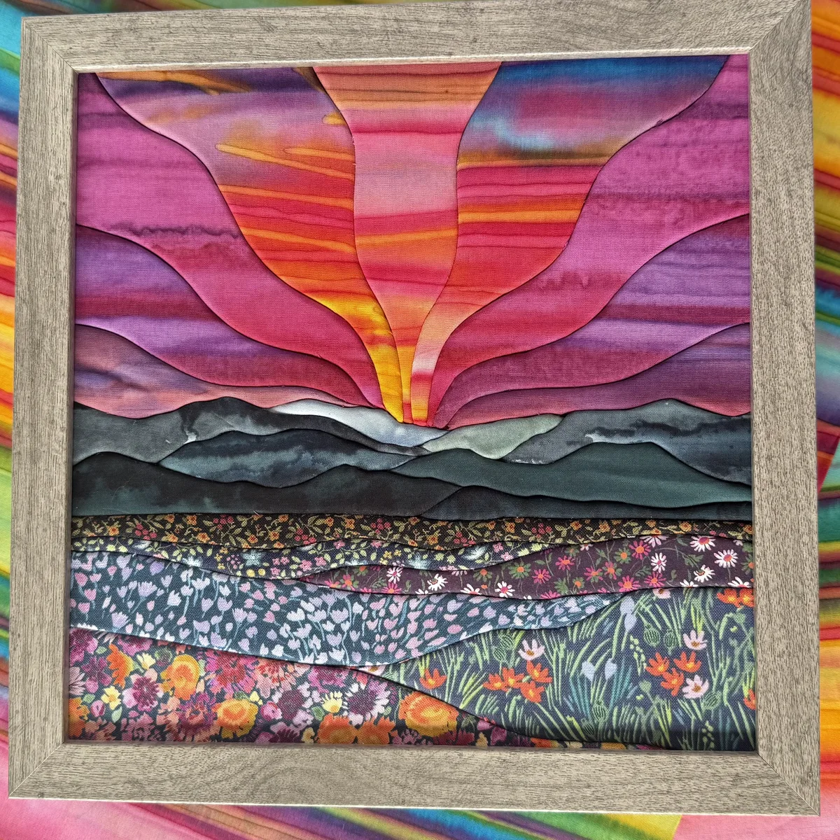 A finished kinusaiga mountain sunrise landscape made of tucked fabric